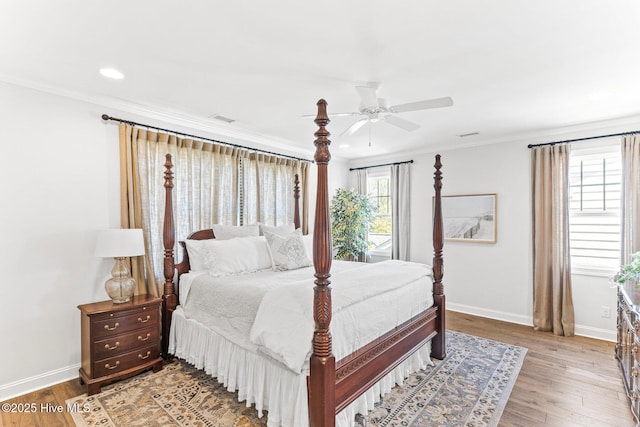 bedroom featuring visible vents, wood finished floors, baseboards, ornamental molding, and recessed lighting