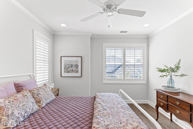 bedroom with visible vents, ornamental molding, baseboards, and wood finished floors