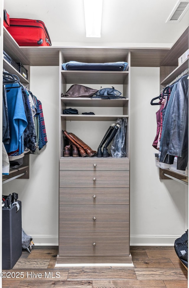 spacious closet featuring wood finished floors and visible vents