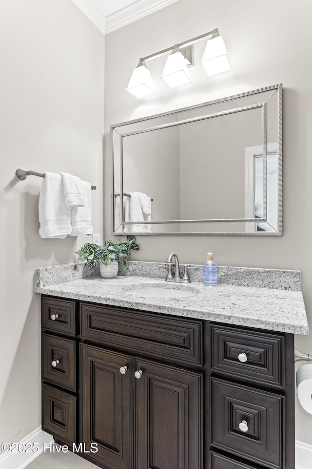 bathroom with ornamental molding and vanity