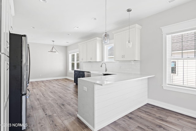 kitchen featuring white cabinetry, appliances with stainless steel finishes, and wood finished floors