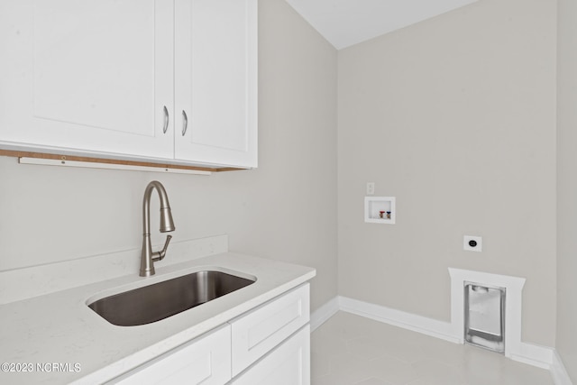 laundry room with baseboards, electric dryer hookup, a sink, cabinet space, and washer hookup