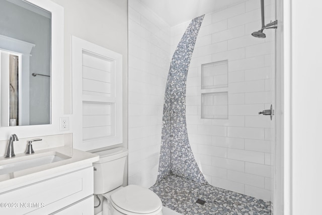full bath featuring vanity, a shower stall, and toilet