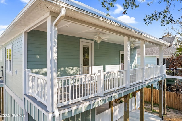 wooden terrace with a porch, a ceiling fan, and fence