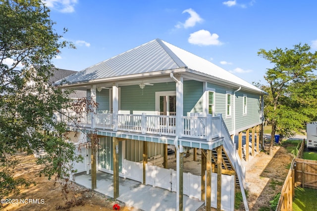 back of house featuring fence, a deck, a ceiling fan, a patio area, and stairway