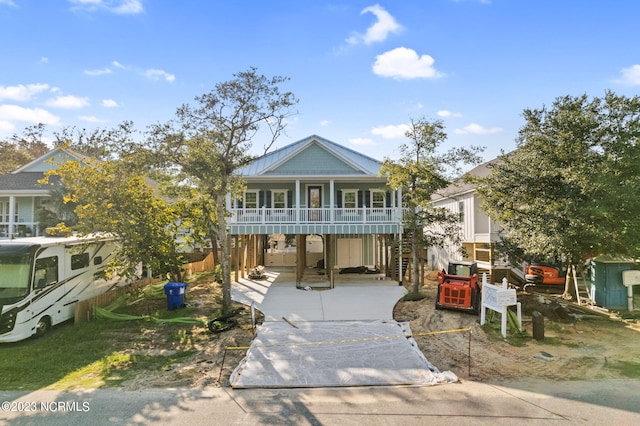 coastal home with a porch and driveway
