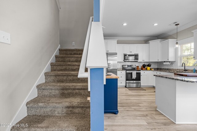 stairway with visible vents, wood finished floors, ornamental molding, and recessed lighting