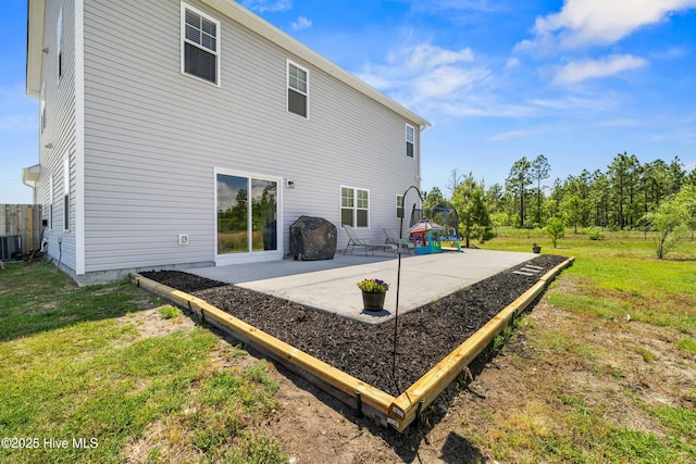 back of property featuring central air condition unit, a patio area, and a lawn