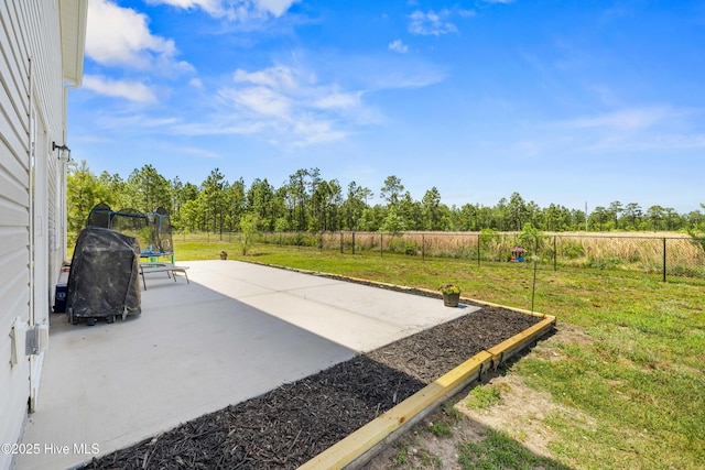 view of patio / terrace with a fenced backyard and a trampoline