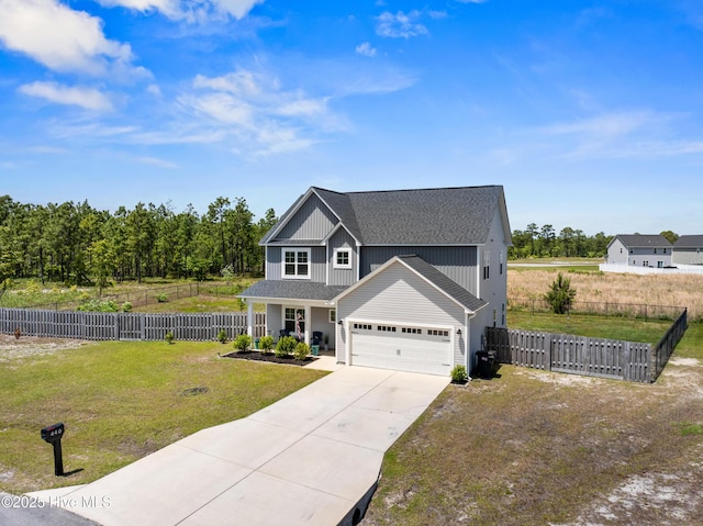 traditional-style home with roof with shingles, fence, a front lawn, and driveway