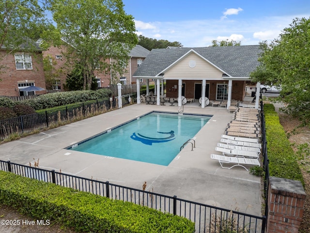 community pool featuring a patio area and fence