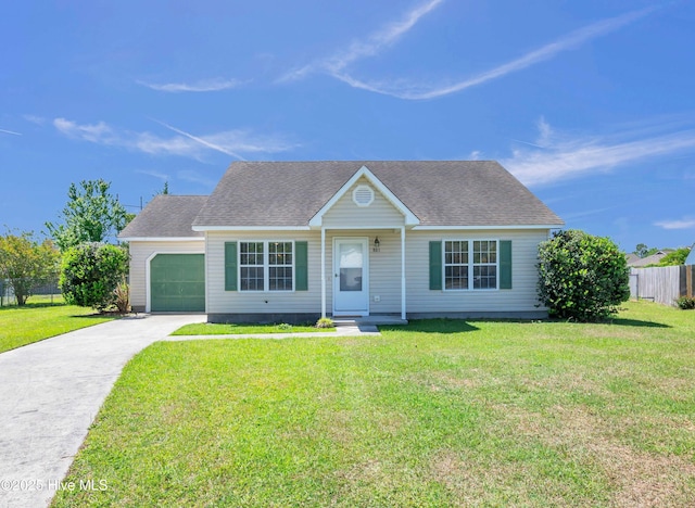 ranch-style home featuring a garage, a front lawn, fence, and driveway