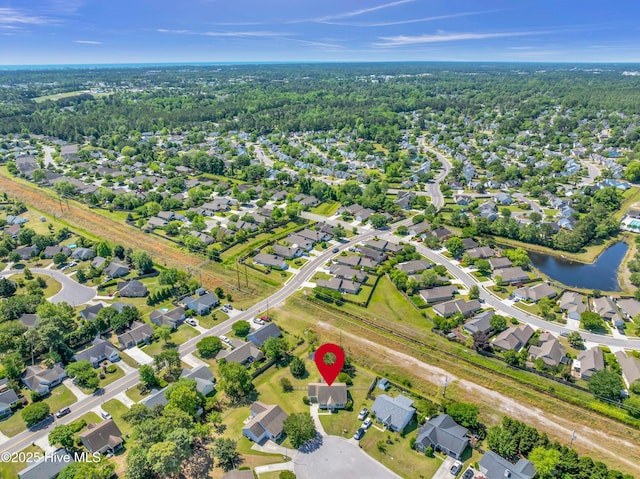 drone / aerial view featuring a water view and a residential view