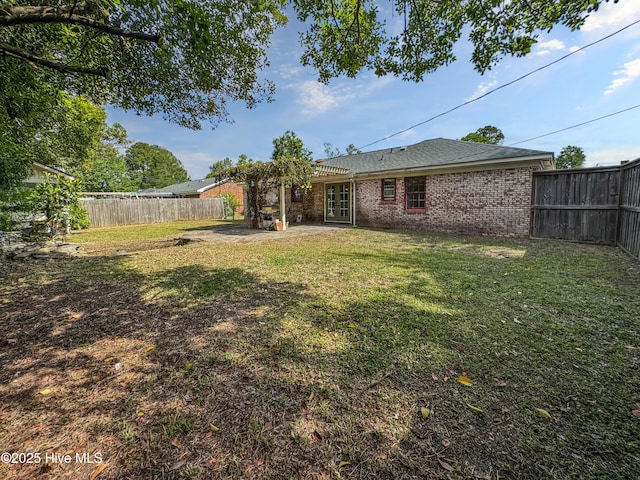 view of yard with french doors and a patio area