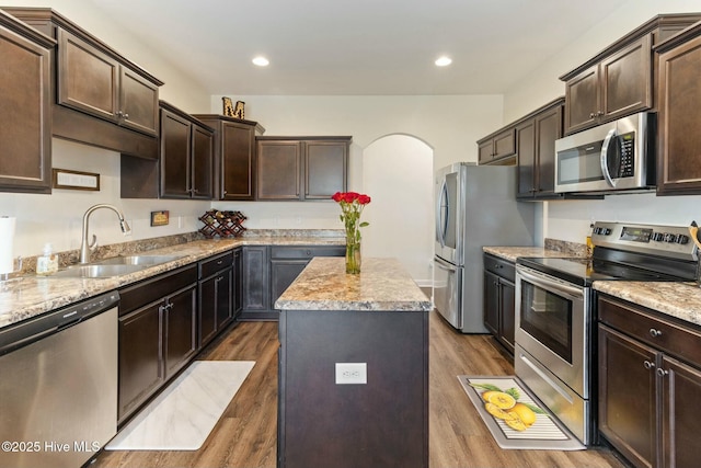 603 Coral Reef Ct, Sneads Ferry, NC 28460 - kitchen with dark wood finished floors, dark brown cabinetry, stainless steel appliances, and a sink