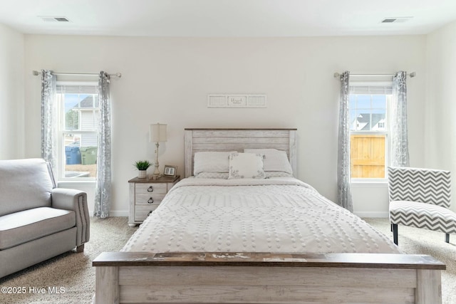 603 Coral Reef Ct, Sneads Ferry, NC 28460 - carpeted bedroom with visible vents, baseboards, and multiple windows