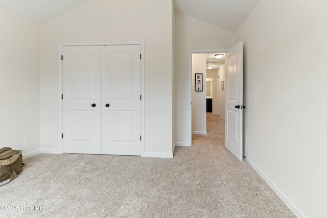603 Coral Reef Ct, Sneads Ferry, NC 28460 - unfurnished bedroom with a closet, vaulted ceiling, carpet floors, and baseboards