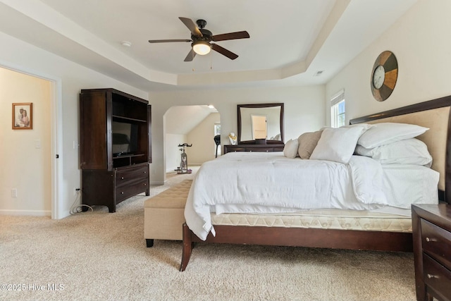 603 Coral Reef Ct, Sneads Ferry, NC 28460 - bedroom with a tray ceiling, visible vents, baseboards, light colored carpet, and ceiling fan