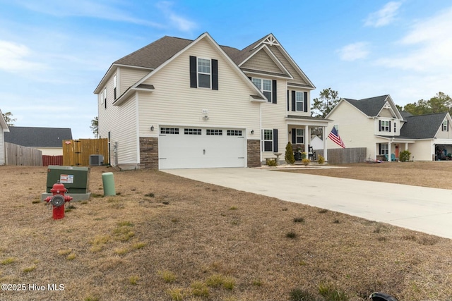 603 Coral Reef Ct, Sneads Ferry, NC 28460 - craftsman house featuring driveway, stone siding, fence, cooling unit, and a garage