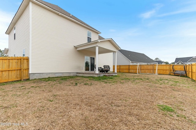 603 Coral Reef Ct, Sneads Ferry, NC 28460 - rear view of property with a fenced backyard, a patio, and a lawn