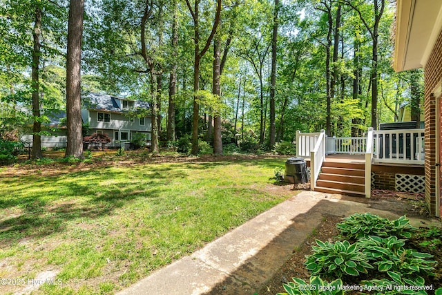 view of yard with a wooden deck and stairway