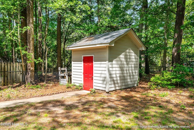 view of shed featuring fence
