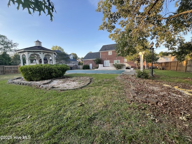 view of yard with a gazebo and fence
