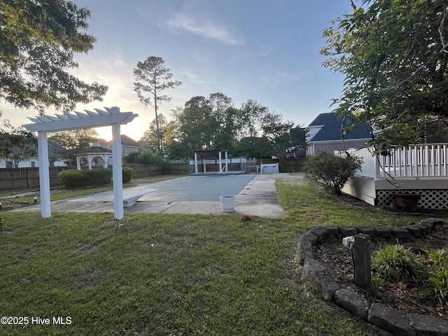 exterior space featuring fence, a pergola, a lawn, and a wooden deck