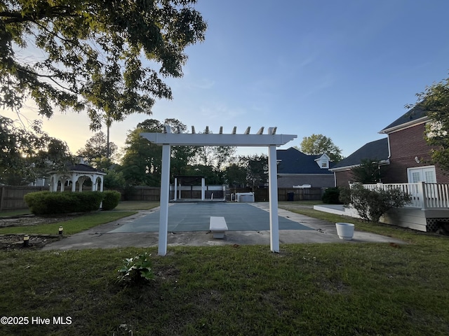 view of yard with fence, a gazebo, and shuffleboard