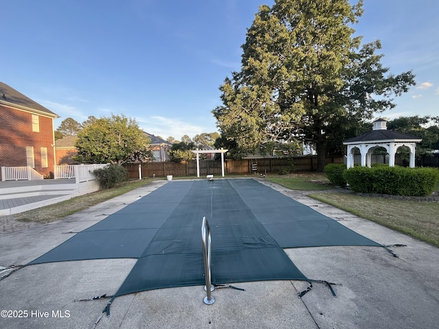 view of pool with a fenced backyard and a gazebo