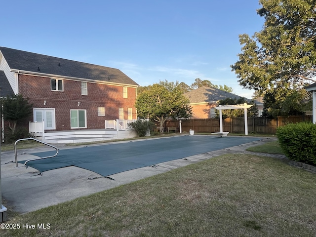 view of pool with a lawn, fence, a fenced in pool, a patio, and a pergola