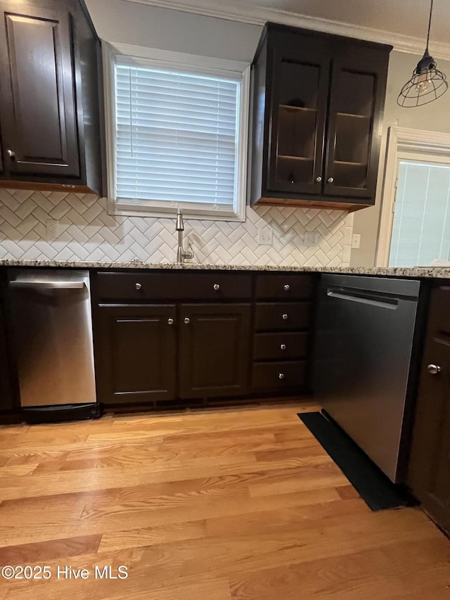 kitchen with ornamental molding, stainless steel dishwasher, and backsplash
