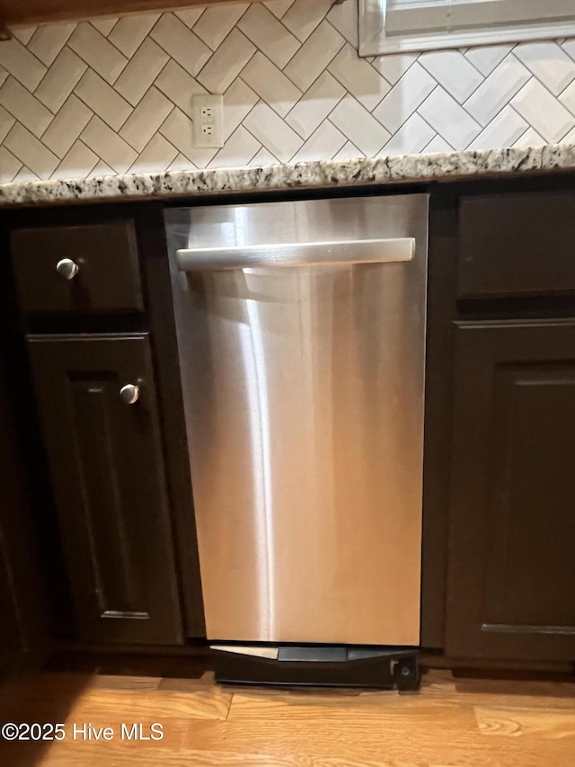 details featuring dark brown cabinetry, light wood-style flooring, and dishwasher