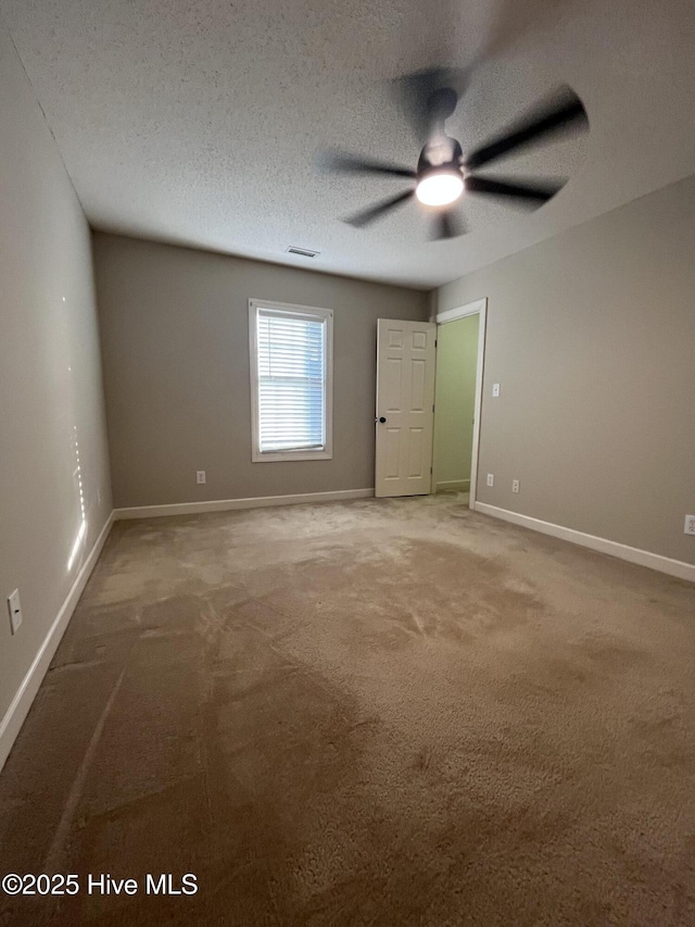 unfurnished bedroom with baseboards, carpet, and visible vents