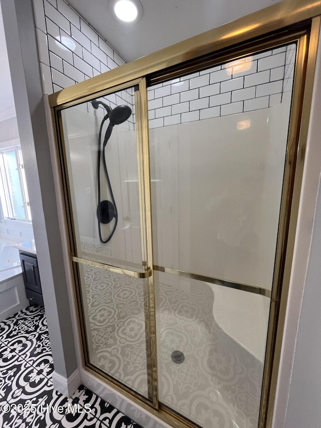 full bathroom featuring a shower stall and tile patterned flooring