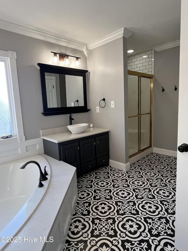 bathroom featuring a garden tub, a shower stall, vanity, baseboards, and ornamental molding