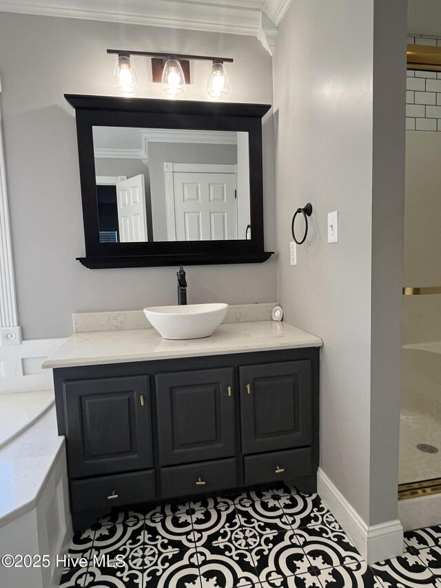 full bathroom featuring vanity, ornamental molding, baseboards, and a shower