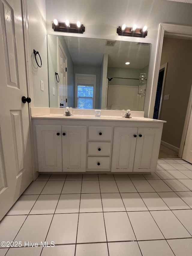 bathroom featuring a sink, tile patterned floors, and double vanity