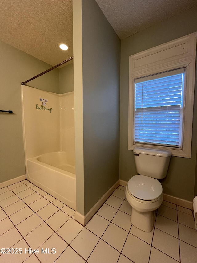 full bath featuring baseboards, a textured ceiling, tile patterned flooring, and toilet