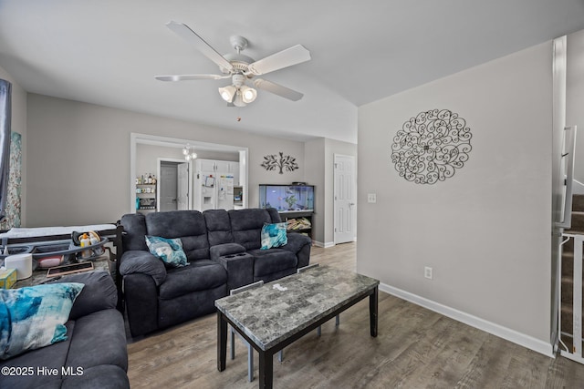 living room with baseboards, a ceiling fan, and wood finished floors