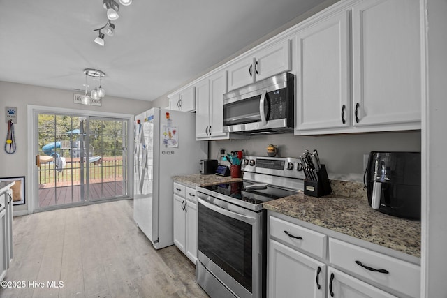 kitchen featuring an inviting chandelier, light wood-type flooring, white cabinetry, light stone counters, and appliances with stainless steel finishes