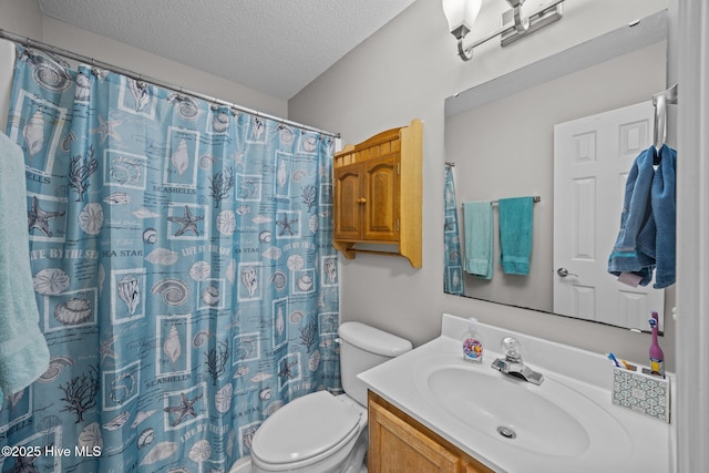 bathroom featuring toilet, a textured ceiling, curtained shower, and vanity
