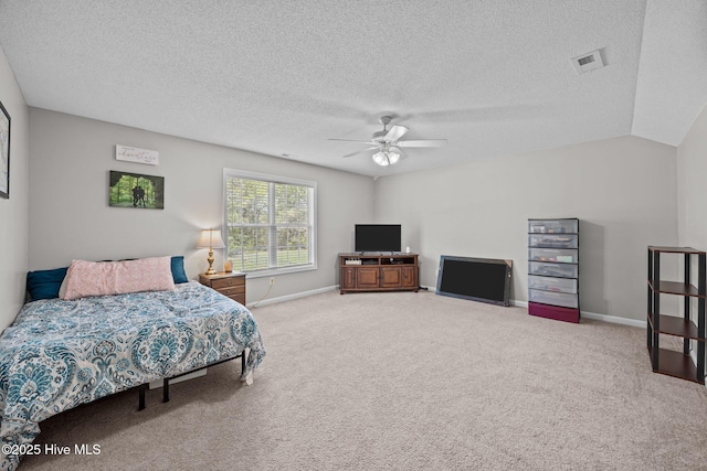 bedroom with carpet floors, a textured ceiling, baseboards, and visible vents