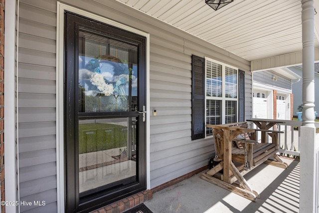 view of exterior entry with covered porch