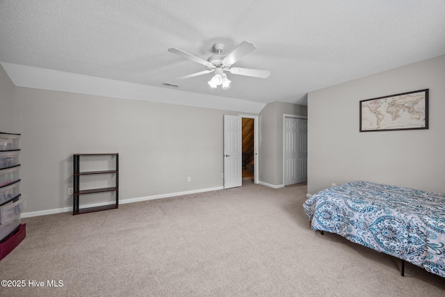 bedroom with visible vents, carpet flooring, a textured ceiling, and a closet