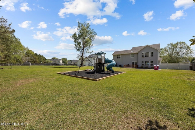view of yard with fence and a playground