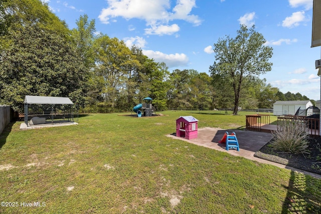 view of yard featuring a playground, a fenced backyard, and a patio area