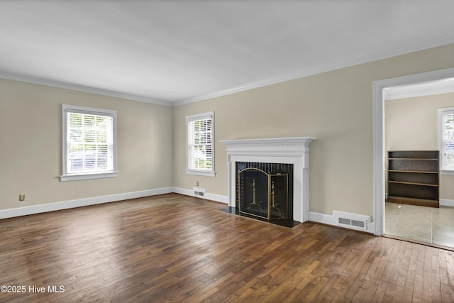 2405 Oleander Dr, Wilmington, NC 28403 - unfurnished living room with wood-type flooring, a wealth of natural light, ornamental molding, and visible vents
