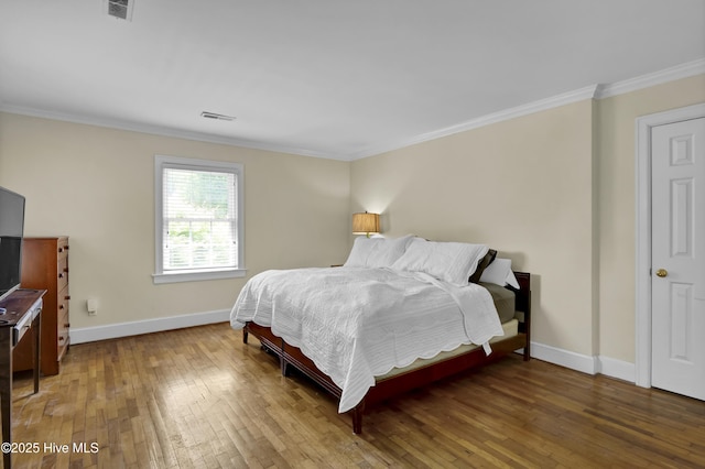 2405 Oleander Dr, Wilmington, NC 28403 - bedroom with visible vents, hardwood / wood-style flooring, baseboards, and crown molding