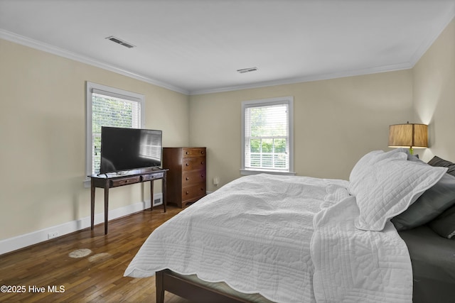 2405 Oleander Dr, Wilmington, NC 28403 - bedroom with ornamental molding, wood finished floors, and visible vents